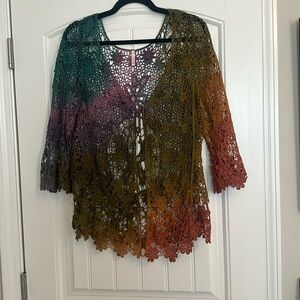 Vintage crocheted top with front tie, three-quarter length sleeves. Size medium.